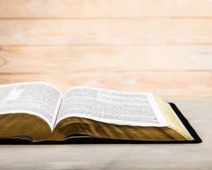 Open Holy bible book on light background