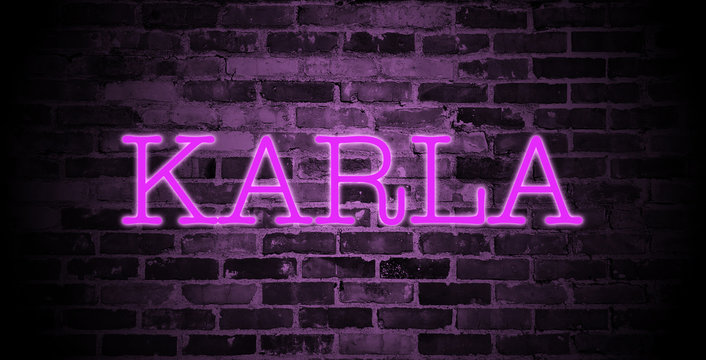 first name Karla in pink neon on brick wall