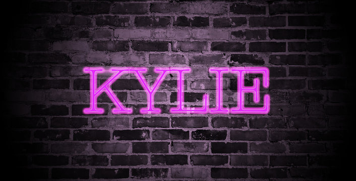 first name Kylie in pink neon on brick wall