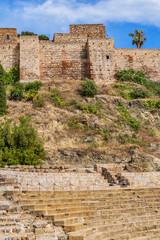 Malaga ancient ruins of Roman Theater (El Teatro Romano) at foot of famous Alcazaba fortress. Roman Theater is oldest monument in Malaga City, it was built in I century BC. Malaga, Andalusia, Spain.
