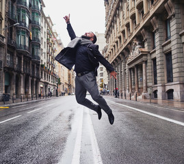 Un chico joven salta en el medio de la calle Via Laietana de Barcelona en un día lluvioso
