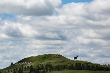 View of Salem Sue on hill against cloudy sky
