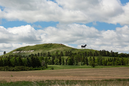 View of Salem Sue on hill against cloudy sky