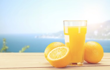 Orange juice and slices of orange on background