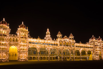 Mysore Palace lighted up with multiple bulbs at night. Royal building in Karnataka, India. Tour visit destination concept