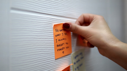 Adding a message sticker on board. Closeup of creative business team brainstorming ideas and concepts