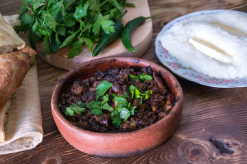 Georgian cuisine - ghomi and kuchmachi with parsley on the wooden table
