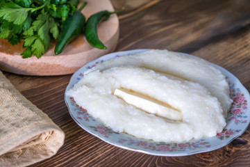 Georgian cuisine - ghomi with cheese on the wooden table