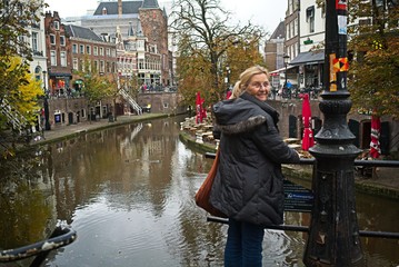 Amsterdam canal with a Dutch woman smiling brightly