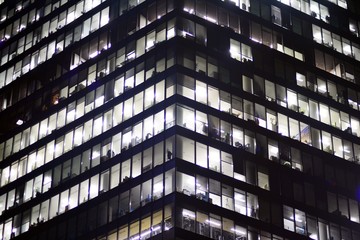 Fototapeta premium Modern office building at night. Night lights, city office building downtown, cityscape view