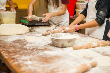 Young children make dough products. Hands closeup