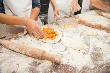 Young children make dough products. Hands closeup