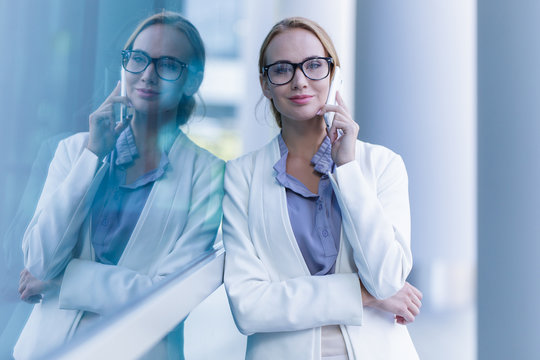 Portrait of beautiful business woman talking on the smartphone outdoor