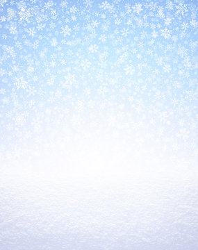 Snowflakes on blue and snow covered ground