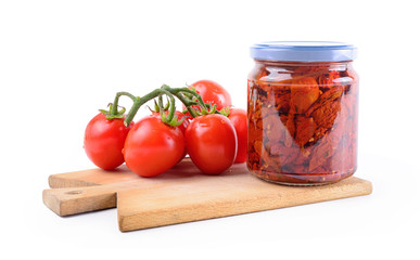 Dried tomatoes in olive oil on white background