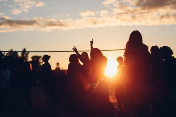 Fotobehang Sunset beach party dancers silhouettes near volleyball court © kondrukhov