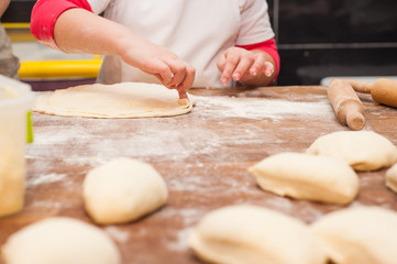 Young children make dough products. Hands closeup