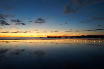 Naklejka premium reflections on the beach with a bridge