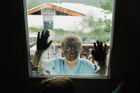 Boy with mud on his face and hands