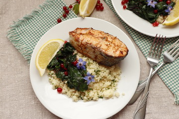 Grilled salmon with couscous, braised chard and red currants.