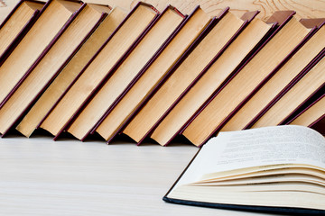 Old books on a wooden shelf. 