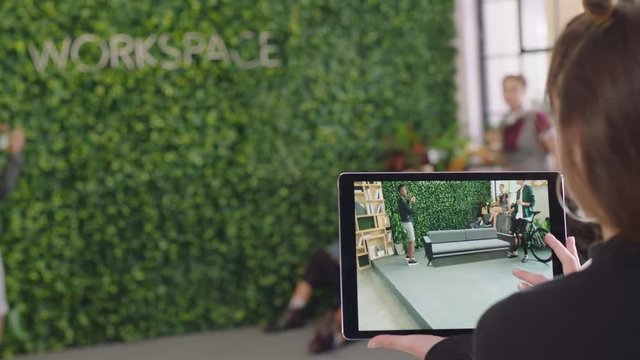 young caucasian woman engineer using digital tablet computer testing virtual reality software planning office layout on screen diverse team enjoying modern workplace teamwork