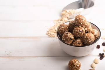 Healthy organic energy granola bolls with nuts, cacao, oats and raisins - vegetarian sweet bites without sugar. Copy space for text