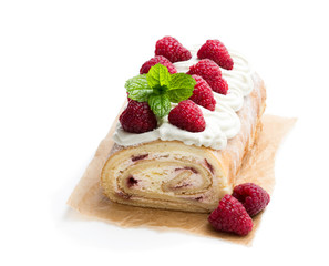 Homemade swiss roll cake with raspberry isolated on white