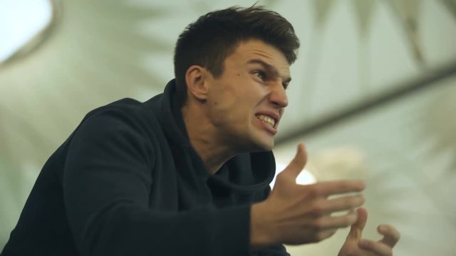 Football fan frustrated with losing game or unfair goal, shouting in desperate