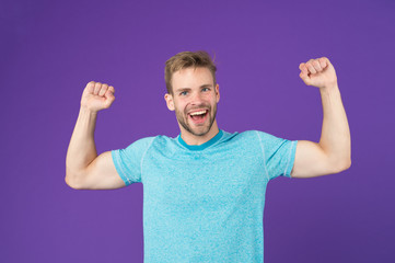 Strong and full of energy. Man strong handsome unshaven guy on violet background. Masculinity...
