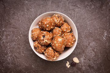 Healthy organic energy granola bolls with nuts, cacao, oats and raisins - vegetarian sweet bites without sugar