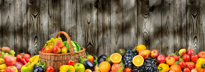 Panoramic photo healthy vegetables and fruits on background wooden wall.