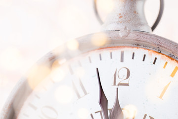 vintage alarm clock is showing midnight. It is twelve o'clock, christmas and bokeh, holiday happy...