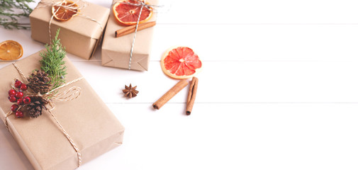 Gift boxes with Christmas decoration on white wooden background. Creative concept. Place for text.