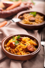 Bigos, a traditional Polish dish with cabbage on brown background