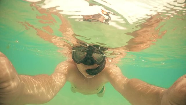 Selfie of man swimming on water surface. gopro dome shot