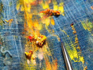 The creative process of the artist. The mess on the table of the artist. Brush in oil paint on the...