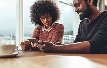 Business colleagues  discussing work at office on a tablet compu