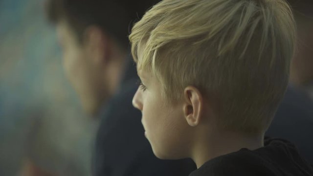 Upset little boy feels lonely and bored, ignored by older brother, close up