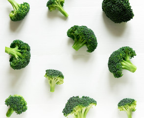 Broccoli pattern. Diet pattern, banner. Photo of broccoli on a white wooden background. Vegans, organic food, diet