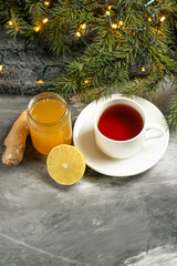 Obraz na płótnie Canvas Lemon and ginger jam with toasts and spices, tea and a branch of the Christmas tree with space for an inscription. The concept of heat, recommendations for the health and support of the immune system