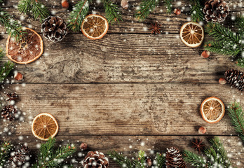 Creative layout frame made of Christmas fir branches, spruce, slices of orange, pine cones,...