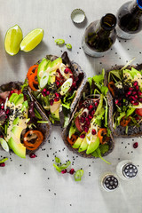 Gluten-free vegan tacos from black bean  with tomato and avocado salad  with tahini sauce and...