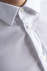 Classic cotton white shirt close up on buttons and collar. Business meeting.