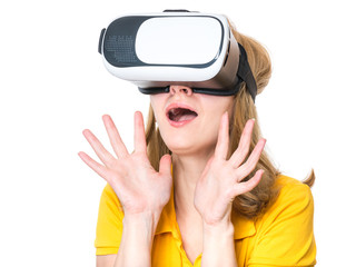 Amazed woman wearing virtual reality goggles watching movies or playing video games, isolated on white background. Surprised girl looking in VR glasses. People experiencing 3D gadget technology.