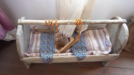 Kas, Antalya, Turkey - 18th of May, 2017: 4K In the Kas Anthropologic museum - Old wooden cradle with pot adjusted for toilet needs