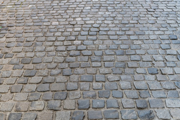 Dark paving stone roadway at european old city