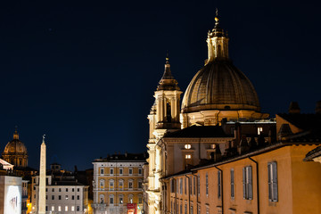The illuminated dome of Sant'Agnese in Agone, or St. Agnes Cathedral late night on the Piazza Navona in Rome, Italy