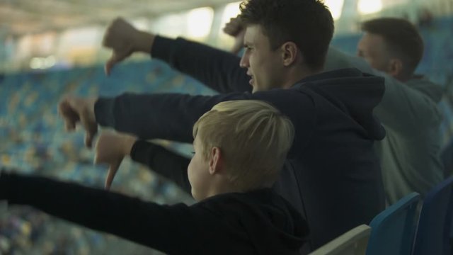 Student Fans And Little Boy Booing Sport Game At Stadium, Watching Junior Match