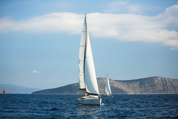Fototapeta premium Sailing luxury boats participate in yacht regatta in the Aegean Sea in Greece.